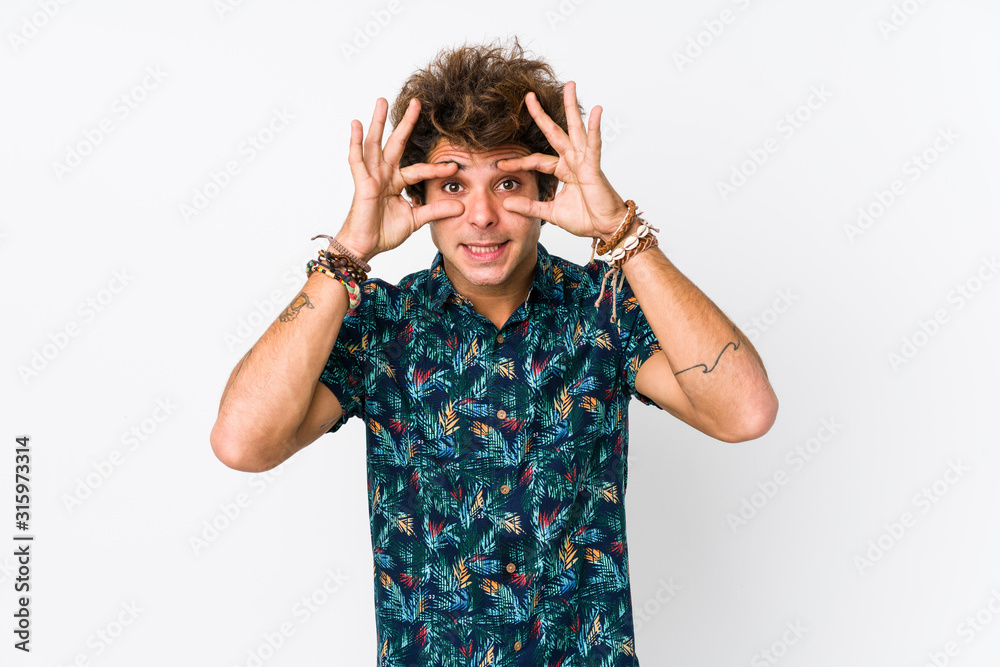 Young caucasian man wearing a flower t-shirt isolated keeping eyes opened to find a success opportunity. Young caucasian man wearing a flower t-shirt isolated keeping eyes opened to find a success opportunity.