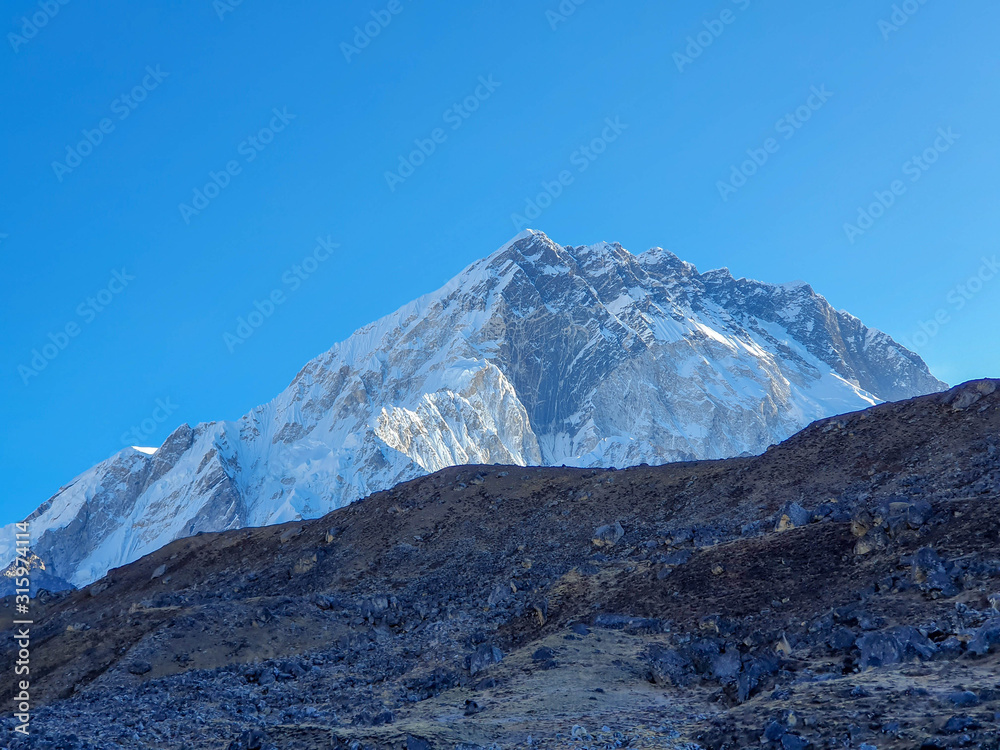 Fototapeta premium Early morning view on Nuptse. Everest base camp trek: from Lobuche to Gorak Shep, Nepal, Himalayas.