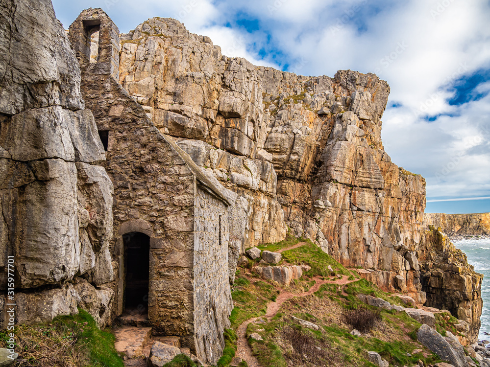 St Govans Chapel. Pembrokeshire, Wales. The chapel is built into the side of a limestone cliff measuring 20 by 12 feet with walls constructed from limestone, and built in the 13th century. St Govans Chapel. Pembrokeshire, Wales. The chapel is built into the side of a limestone cliff measuring 20 by 12 feet with walls constructed from limestone, and built in the 13th century.