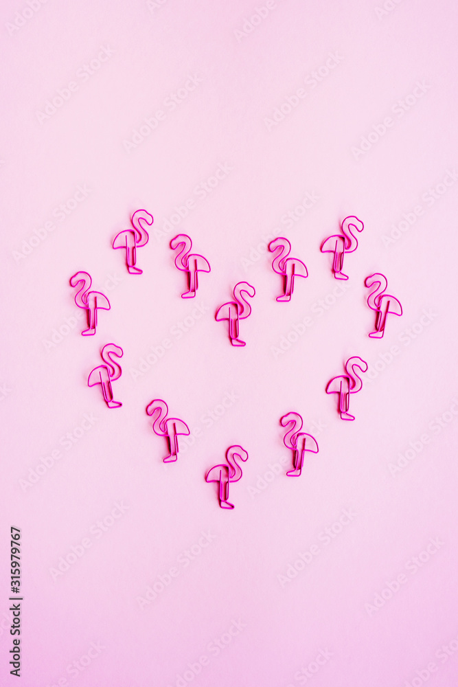 The heart of pink paper clips in the shape of flamingos. Pink flamingo spsies. Happy Valentine's Day. Heart, Love.