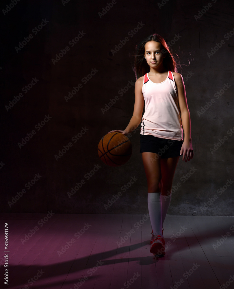 Female basketball player bouncing the ball Female basketball player bouncing the ball