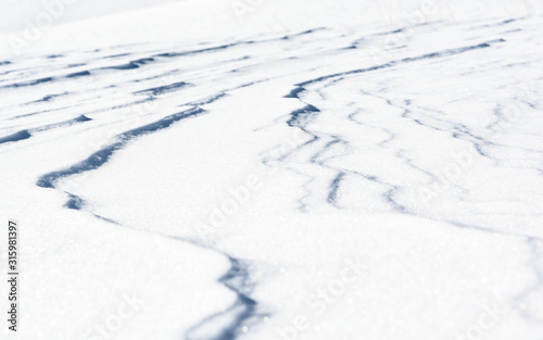 Fresh snow background texture. Winter background with snowflakes and snow mounds.