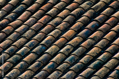 Overlapping red tile roof, worn tiles