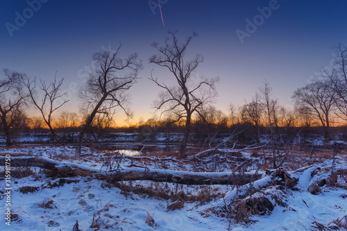 Early winter, with some snow on the landscape.