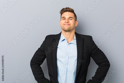 Young handsome caucasian man confident keeping hands on hips.