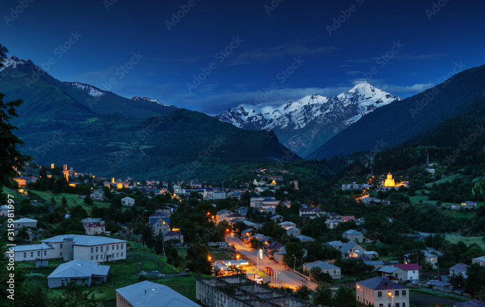 View of the village at the foot of a majestic mountain. 