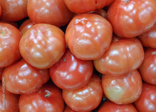 Fresh red tomatoes in a supermarket. Tomato texture, background. Copy space.