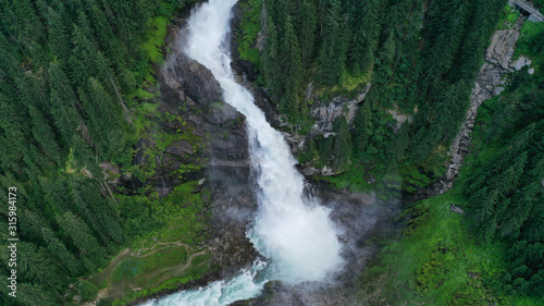 Aerial view of Krimml waterfall, cascades. Landscape with spruces, fir tree forest, stones, water flowing from mountains. Salzburg land, Austria.