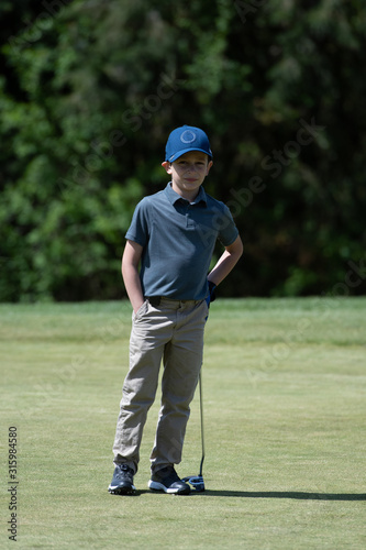 Junior Golfer Waiting to Putt