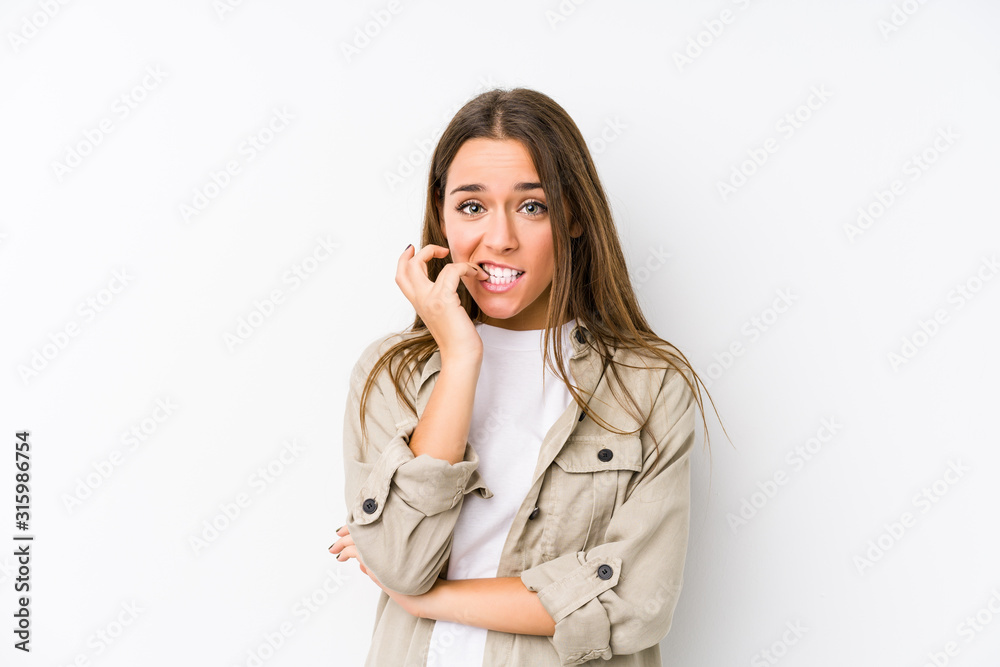 Young caucasian woman isolated biting fingernails, nervous and very anxious. Young caucasian woman isolated biting fingernails, nervous and very anxious.