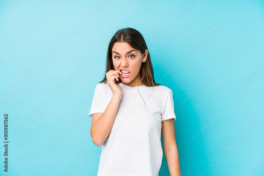 Young caucasian woman isolated biting fingernails, nervous and very anxious. Young caucasian woman isolated biting fingernails, nervous and very anxious.