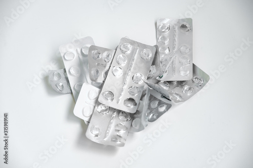 Used drugs, Used capsules, Used antibiotic packaging on white background, Close-up of empty package