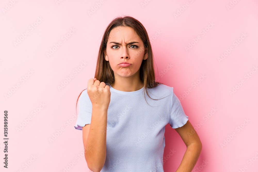 Young caucasian woman wearing a ski clothes isolated showing fist to camera, aggressive facial expression. Young caucasian woman wearing a ski clothes isolated showing fist to camera, aggressive facial expression.