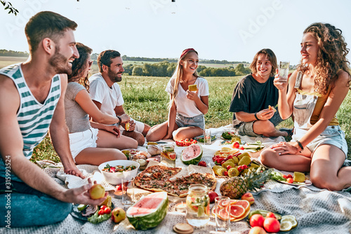 Group of young attractive friends having a picnic