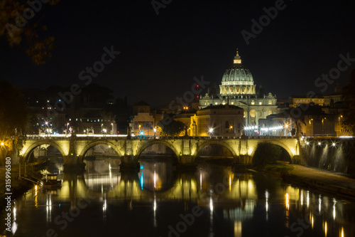 Night scene of Rome, Tevere river with basilica in background