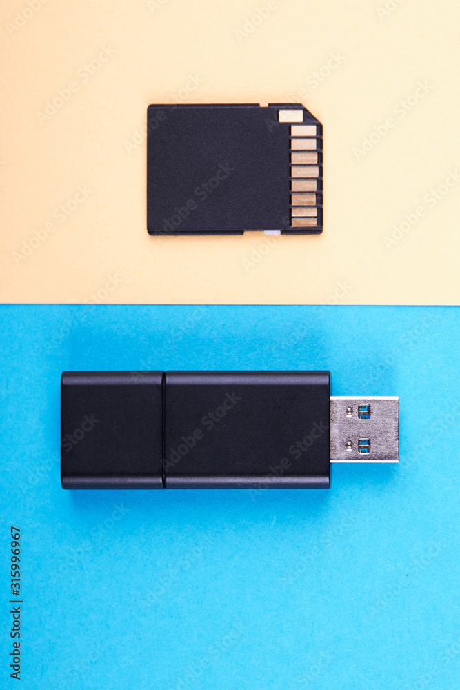 usb flash stick and micro sd memory card on blue and yellow background.  different kind of portable storage devices. data store concept. Stock Photo  | Adobe Stock