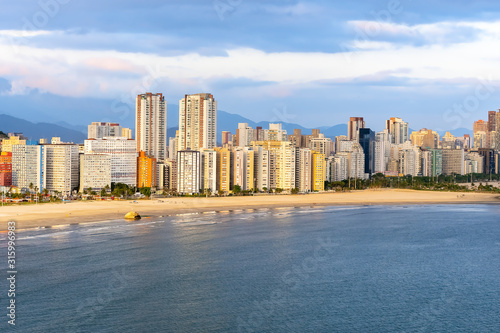 Aerial view of two Brazilian coastal cities of the Paulista coast. End of Praia do Itarare beach at Sao vicente city border with Santos city, Jose Menino beach. photo