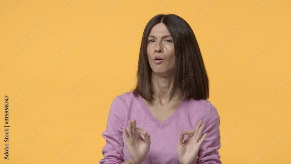 Slow-motion dissatisfied brunette mother, daughter asking permission go party, woman strongly disagree, shake head in denial, saying no, reject offer, refusing, standing yellow background Slow-motion dissatisfied brunette mother, daughter asking permission go party, woman strongly disagree, shake head in denial, saying no, reject offer, refusing, standing yellow background