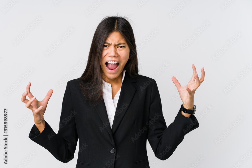 Young asian business woman screaming with rage. Young asian business woman screaming with rage.