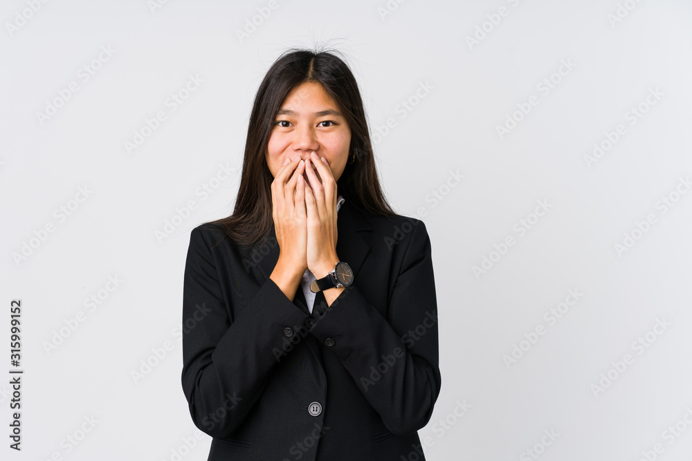 Young asian business woman laughing about something, covering mouth with hands. Young asian business woman laughing about something, covering mouth with hands.