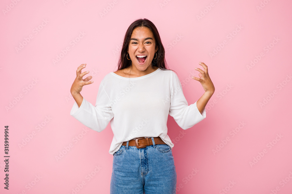 Young mixed race indian woman screaming with rage. Young mixed race indian woman screaming with rage.