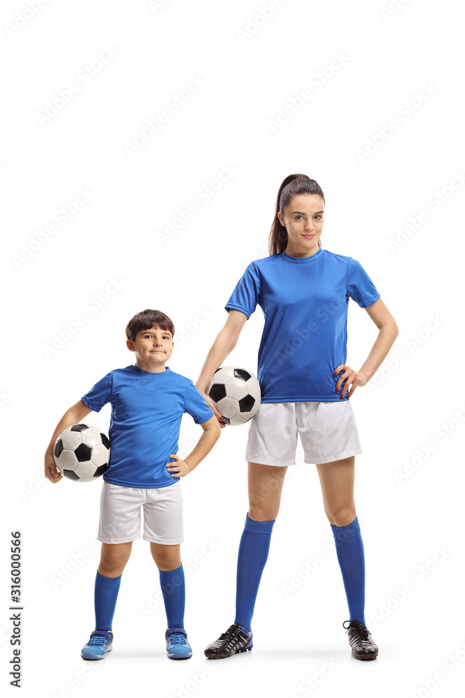Boy and young female in sports jersey holding soccer balls Boy and young female in sports jersey holding soccer balls