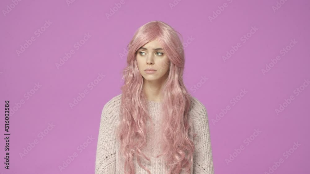 Slow-motion sad and grieving young cute, kawaii young girl in pink wig, wipe teardrop from eye, feeling uneasy mourning, express sadness and depression, standing pink background Slow-motion sad and grieving young cute, kawaii young girl in pink wig, wipe teardrop from eye, feeling uneasy mourning, express sadness and depression, standing pink background