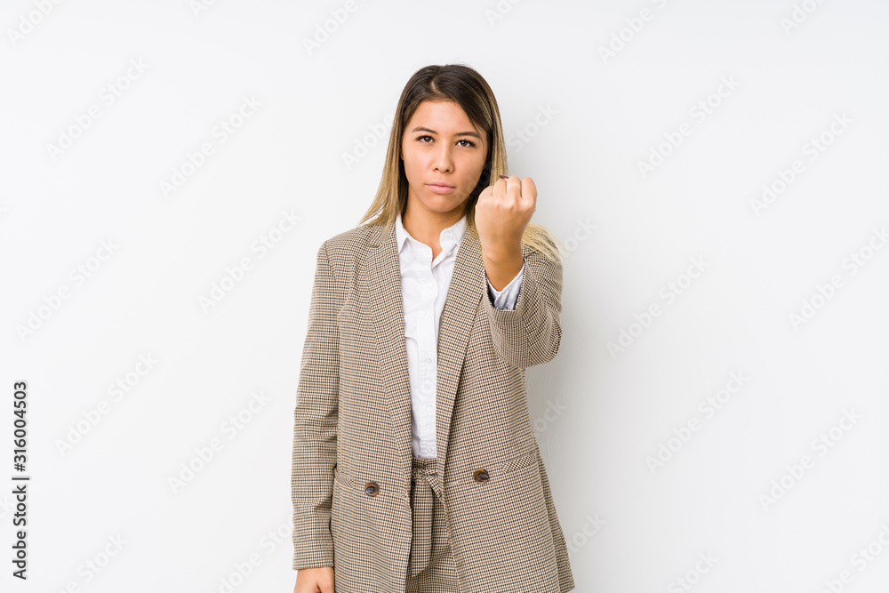 Young caucasian business woman isolated showing fist to camera, aggressive facial expression. Young caucasian business woman isolated showing fist to camera, aggressive facial expression.