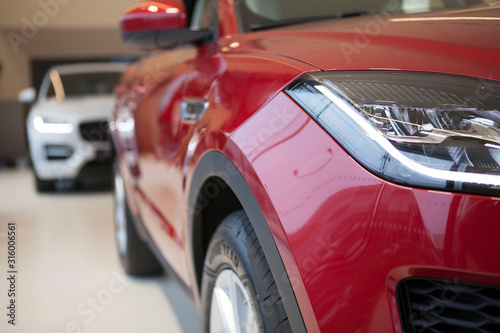 Cropped close up of a new modern automobile on sale at local dealership salon. Car sales concept © mad_production