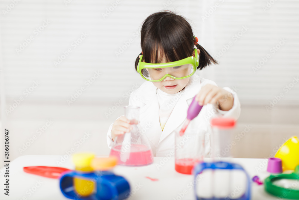 toddler girl pretend play scientist role at home against white background toddler girl pretend play scientist role at home against white background