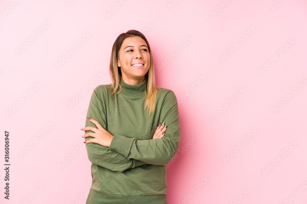 Fototapeta premium Young caucasian woman posing isolated smiling confident with crossed arms.
