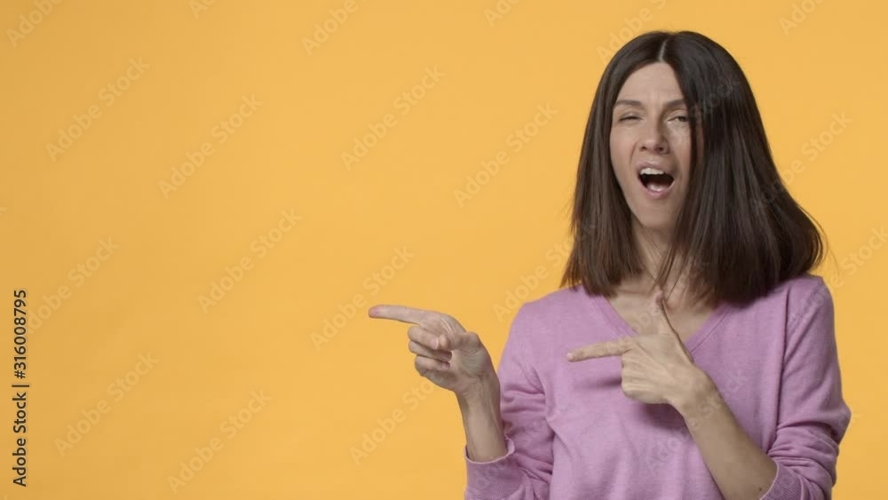 Slow-motion excited, sassy and confident, energized middle-aged woman, adult female introduce product, pointing hands left side empty copy space, smiling show thumb-up, recommend choose it Slow-motion excited, sassy and confident, energized middle-aged woman, adult female introduce product, pointing hands left side empty copy space, smiling show thumb-up, recommend choose it