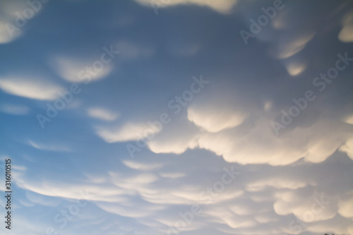 Beautiful clouds with blue sky background. Nature weather, mammatus cloud sky photo