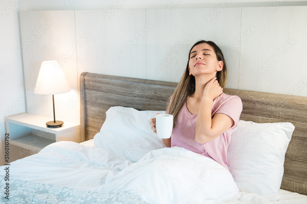attractive woman with eyes closed holding a cup of coffee or tea. woman relaxing after a hard day attractive woman with eyes closed holding a cup of coffee or tea. woman relaxing after a hard day