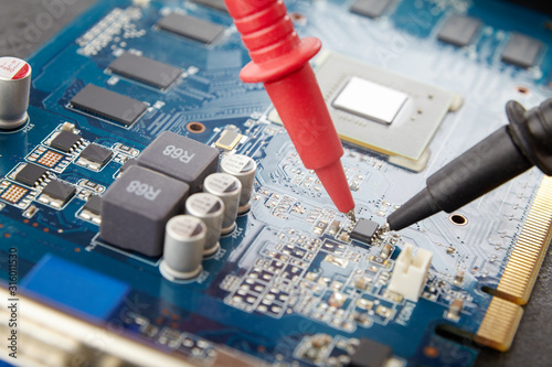 blue circuit board close-up diagnostics, the electronic component is being tested.