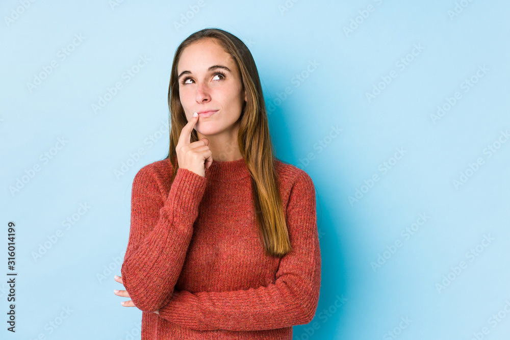 Young caucasian woman posing isolated looking sideways with doubtful and skeptical expression. Young caucasian woman posing isolated looking sideways with doubtful and skeptical expression.