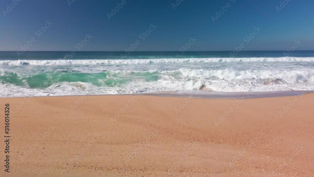 View of the Ocean Waves from Sandy Beach, sunny day View of the Ocean Waves from Sandy Beach, sunny day