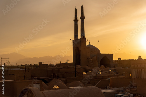 Views of the skyline with minarets and domes of Yazd at sunset, Iran photo