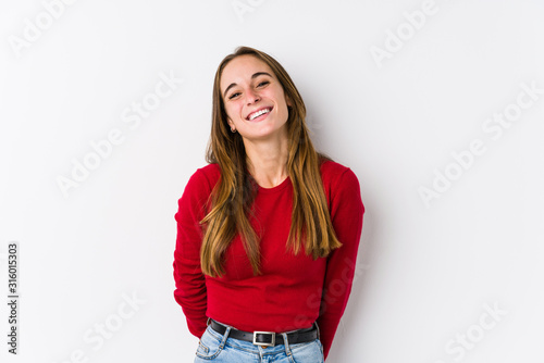 Young caucasian woman posing isolated laughs and closes eyes, feels relaxed and happy.