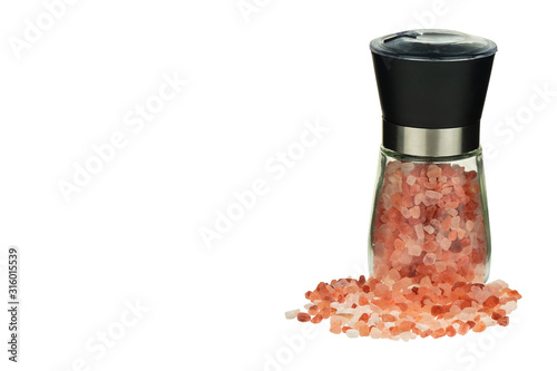 Pink Himalayan salt crystals in a glass grinder. Himalayan pink salt in mill isolated on white background.  Mill Grinder mock up.