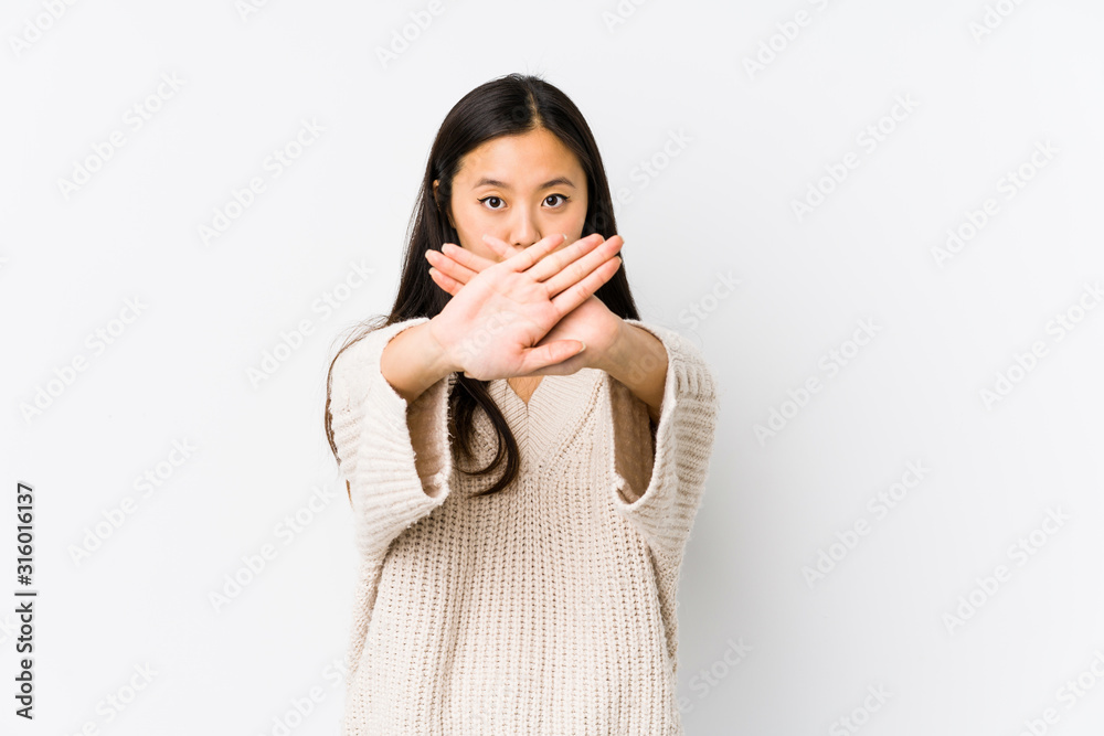 Young chinese woman isolated doing a denial gesture Young chinese woman isolated doing a denial gesture