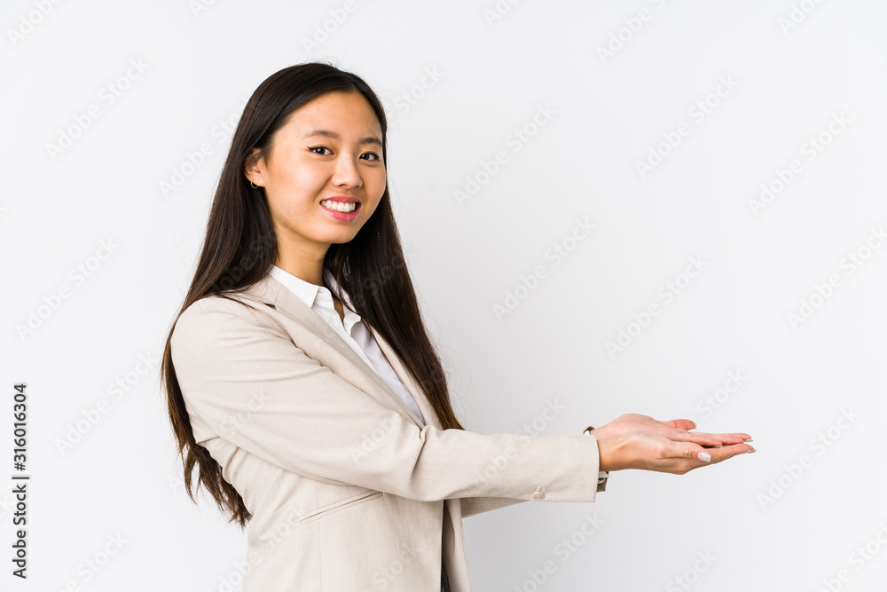Young business chinese woman isolated holding a copy space on a palm. Young business chinese woman isolated holding a copy space on a palm.