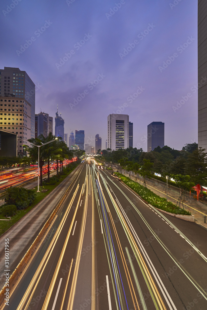 Light trails on the busy road of Jakarta business office center in the dusk