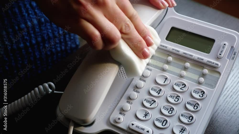 Demo shot of white sponge cleaning telephone hand set Demo shot of white sponge cleaning telephone hand set