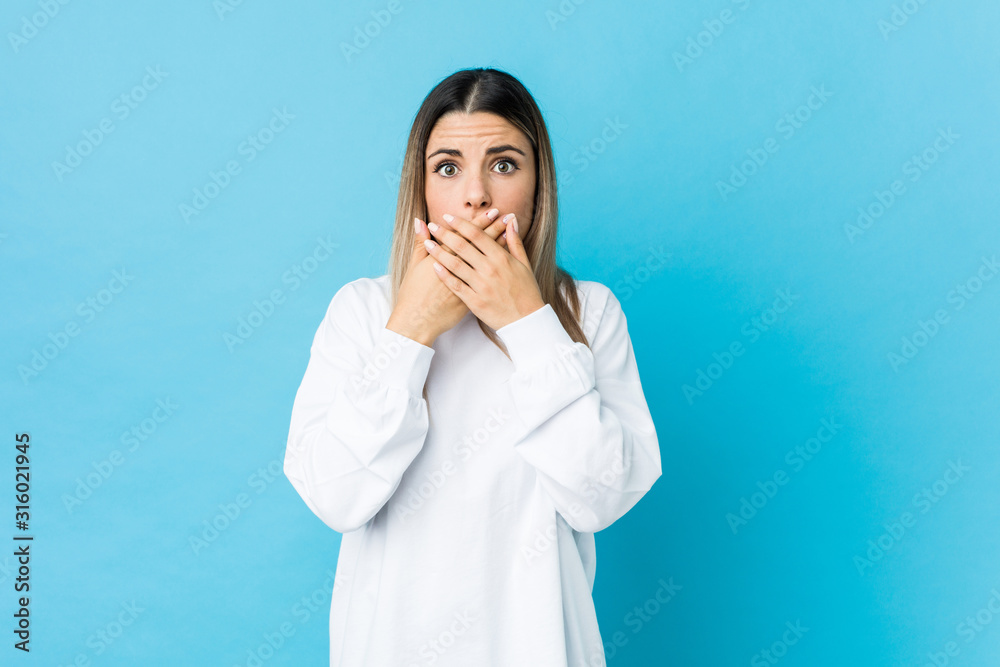 Young caucasian woman isolated shocked covering mouth with hands. Young caucasian woman isolated shocked covering mouth with hands.