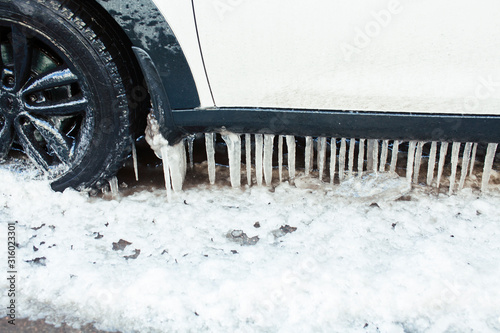 close up photo off car in iciles, a lot of water and snow, seasonal issues concept photo