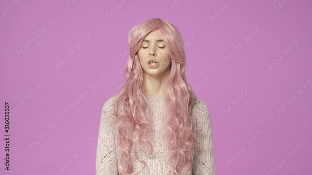 Slow-motion serious-looking displeased female in pink kawaii wig talking, having intense conversation, shake head in refusal, saying no, shaking hands, making stop gesture, rejecting, being reluctant