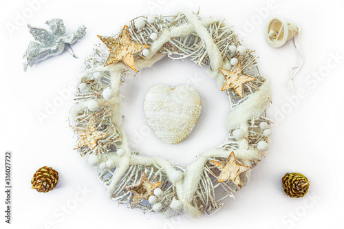 Obraz na płótnie Christmas wreath made from dried twigs, decorated with heart, stars, angel, cones and bell. w salonie
