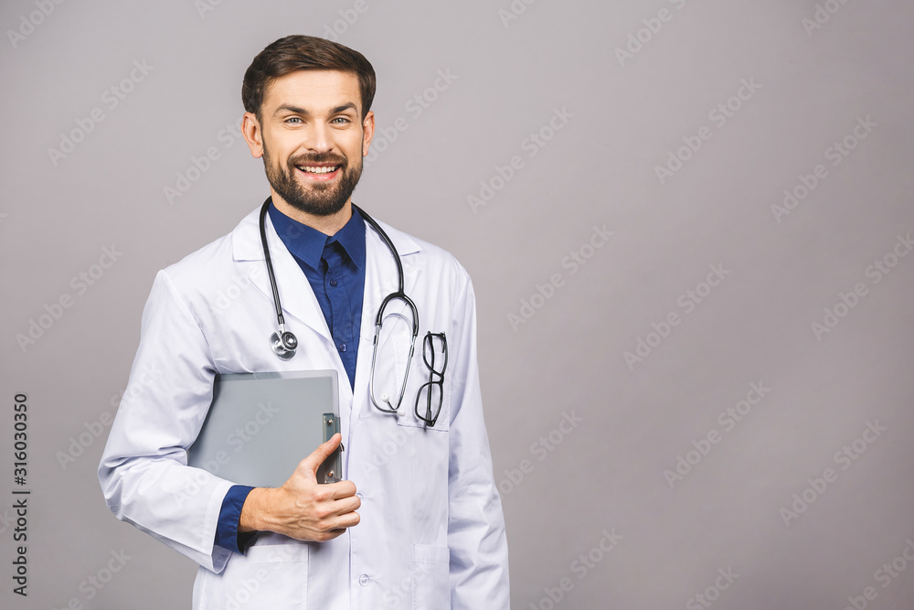 Portrait of smiling male doctor holding clipboard isolated on grey background. Portrait of smiling male doctor holding clipboard isolated on grey background.
