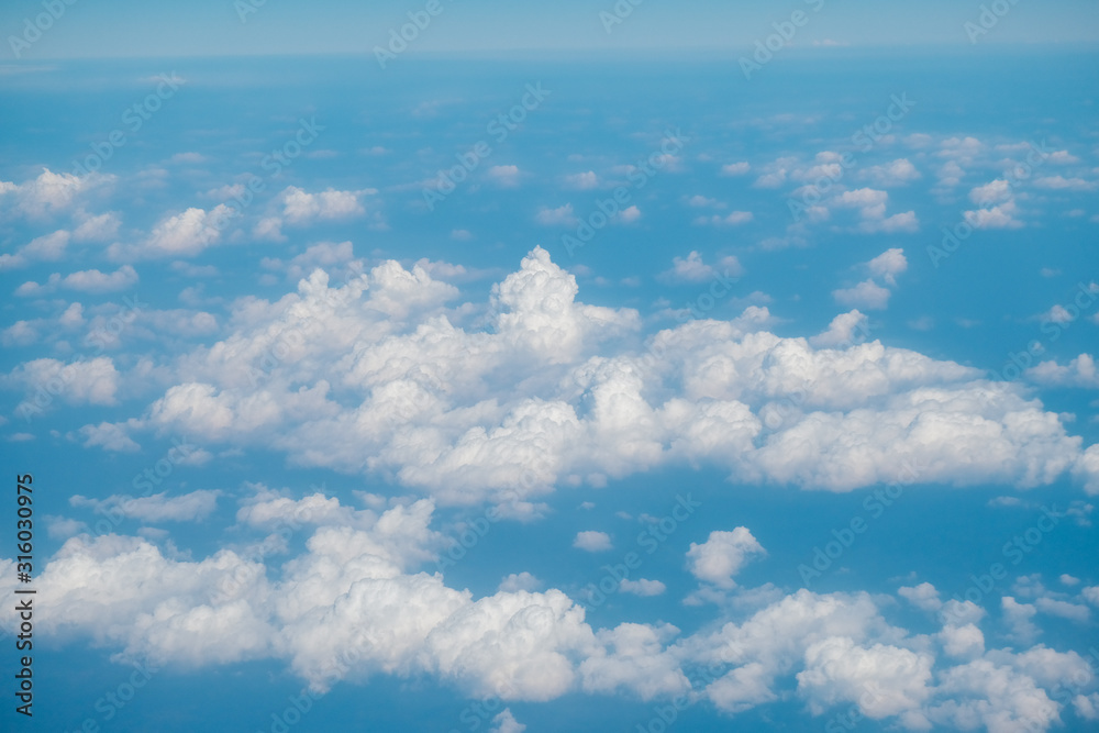 Fluffy white cloud with blue sky above view from airplane Fluffy white cloud with blue sky above view from airplane